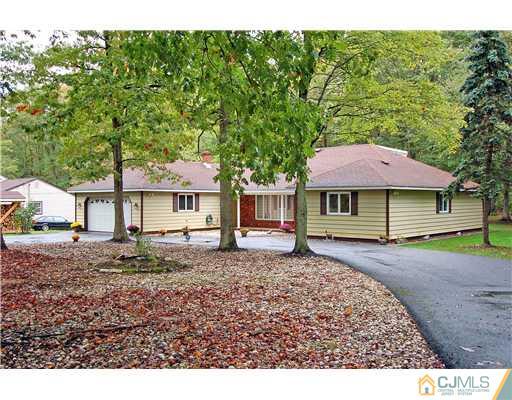 148 Broadway Road Cranbury, NJ 08512 - Photo 1 of 17 a front view of a house with a garden
