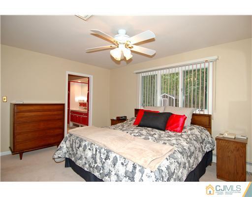 148 Broadway Road Cranbury, NJ 08512 - Photo 11 of 17 a bedroom with a bed and a chandelier
