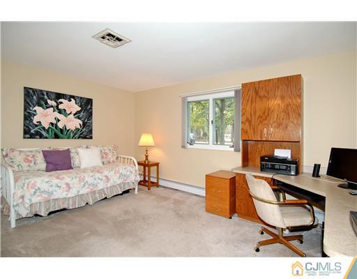 148 Broadway Road Cranbury, NJ 08512 - Photo 14 of 17 a bedroom with a bed and wooden floor