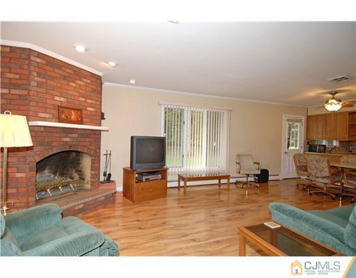 148 Broadway Road Cranbury, NJ 08512 - Photo 3 of 17 a living room with furniture and a fireplace