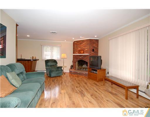 148 Broadway Road Cranbury, NJ 08512 - Photo 4 of 17 a living room with furniture and a fireplace