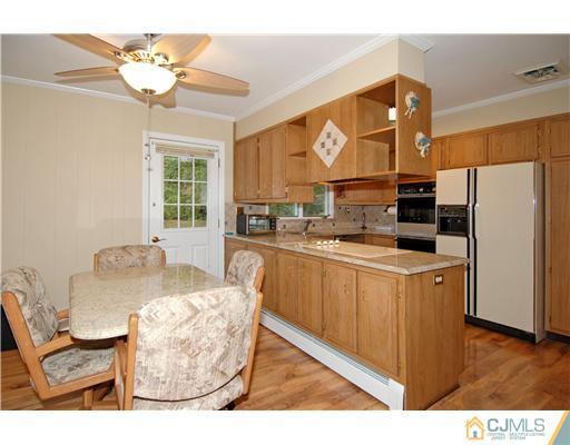 148 Broadway Road Cranbury, NJ 08512 - Photo 6 of 17 a kitchen with stainless steel appliances granite countertop a refrigerator a sink dishwasher a dining table and with couches