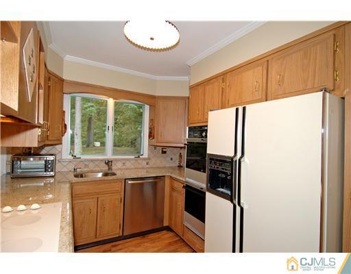 148 Broadway Road Cranbury, NJ 08512 - Photo 7 of 17 a kitchen with a sink a refrigerator and window