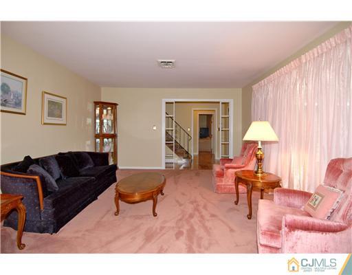 148 Broadway Road Cranbury, NJ 08512 - Photo 9 of 17 a living room with furniture and a lamp
