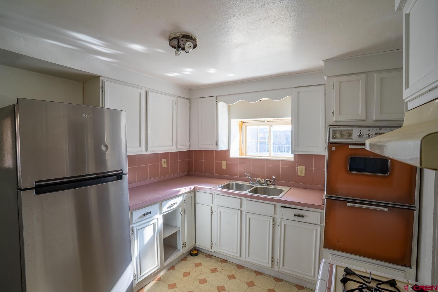 120 Browning Avenue Ignacio, CO 81137 - Photo 8 of 36 a kitchen with a refrigerator sink stove and cabinets