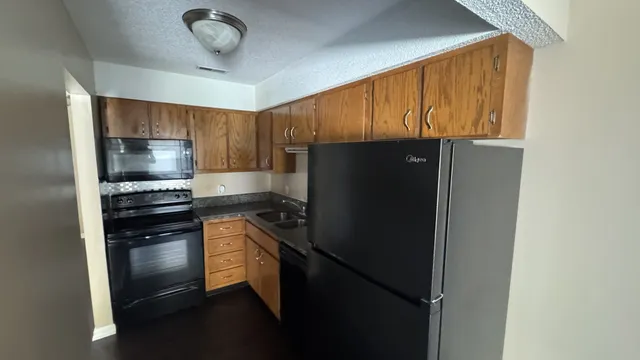 a kitchen with a refrigerator and a stove