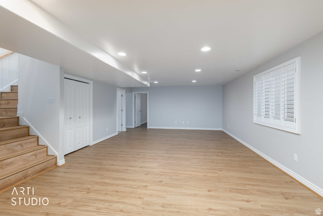 2327 Bluff Ridge Drive Syracuse, UT 84075 - Photo 32 of 66 Spacious room featuring wood-finish flooring, recessed lighting, and a window with white louvered shutters