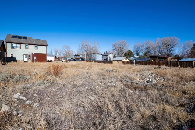 a view of a dirt road and a building