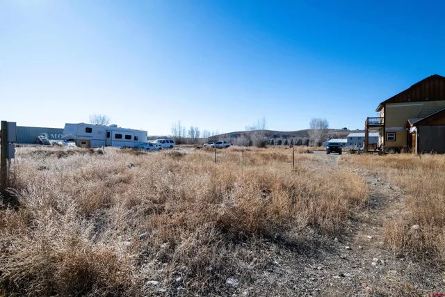 a view of a dirt road with a building