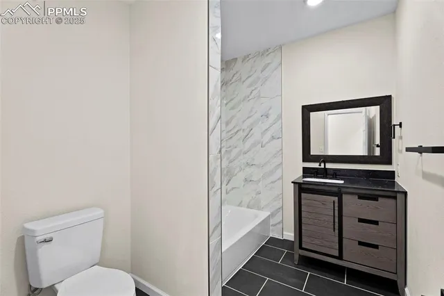 a bathroom with a toilet a sink and bathtub