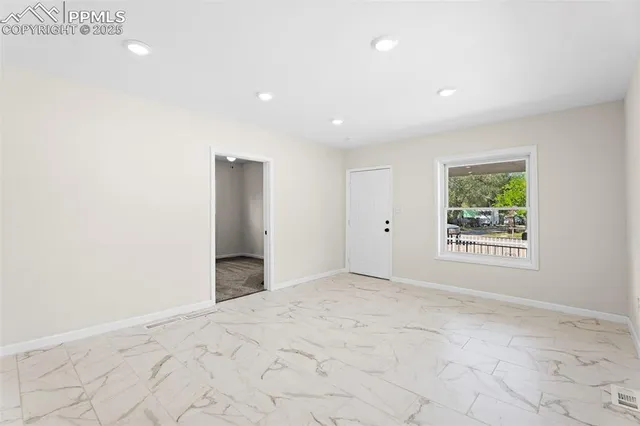 a view of an empty room with a window