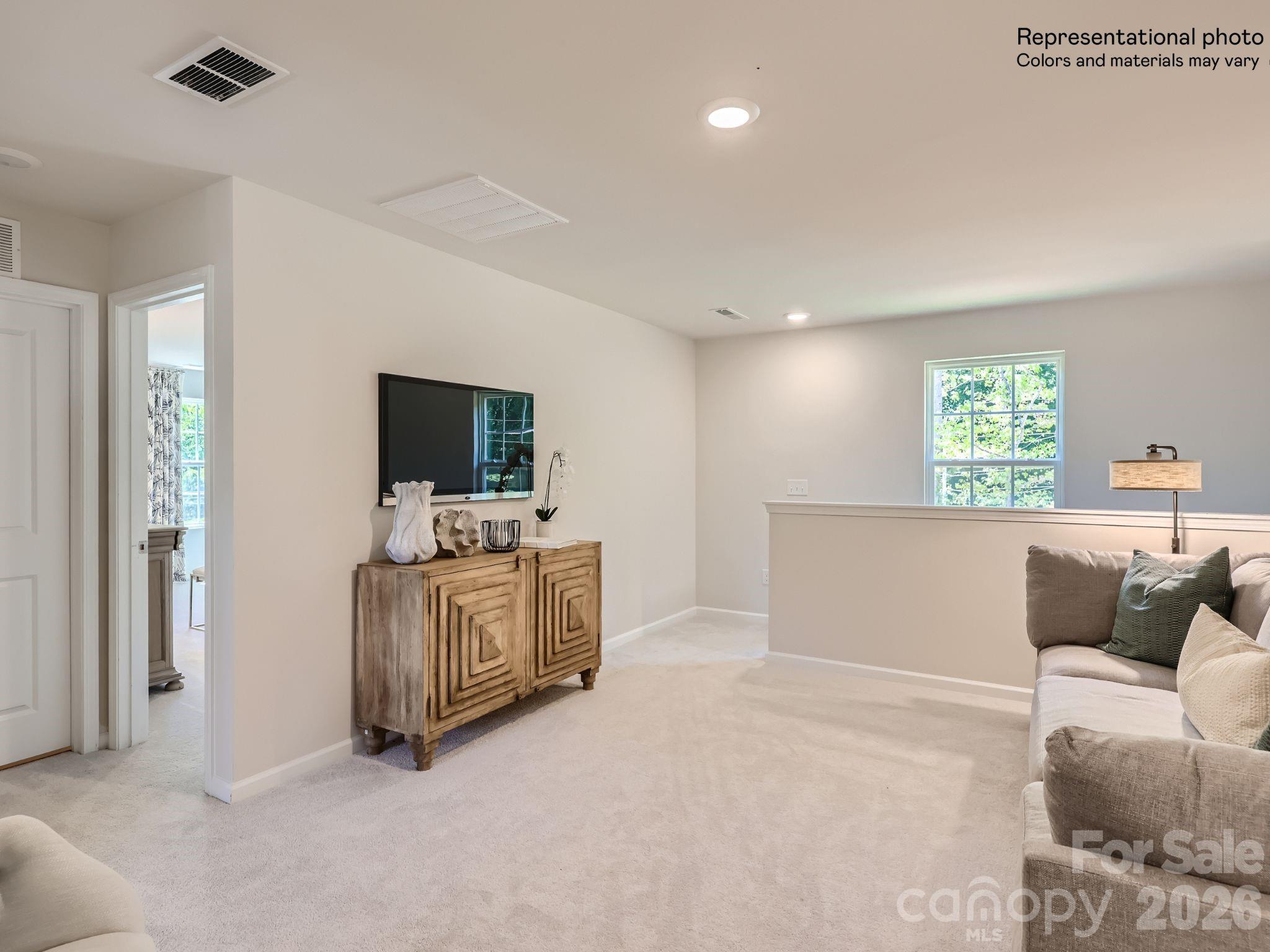 159 Astor Street Troutman, NC 28166 - Photo 12 of 24 a living room with furniture and a flat screen tv