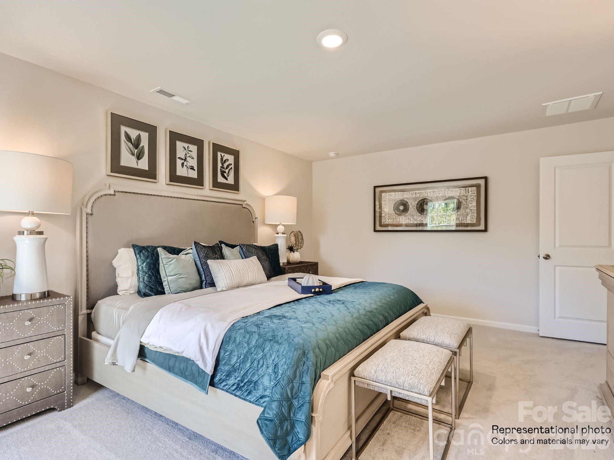 159 Astor Street Troutman, NC 28166 - Photo 15 of 24 a bedroom with a bed and a painting on the wall