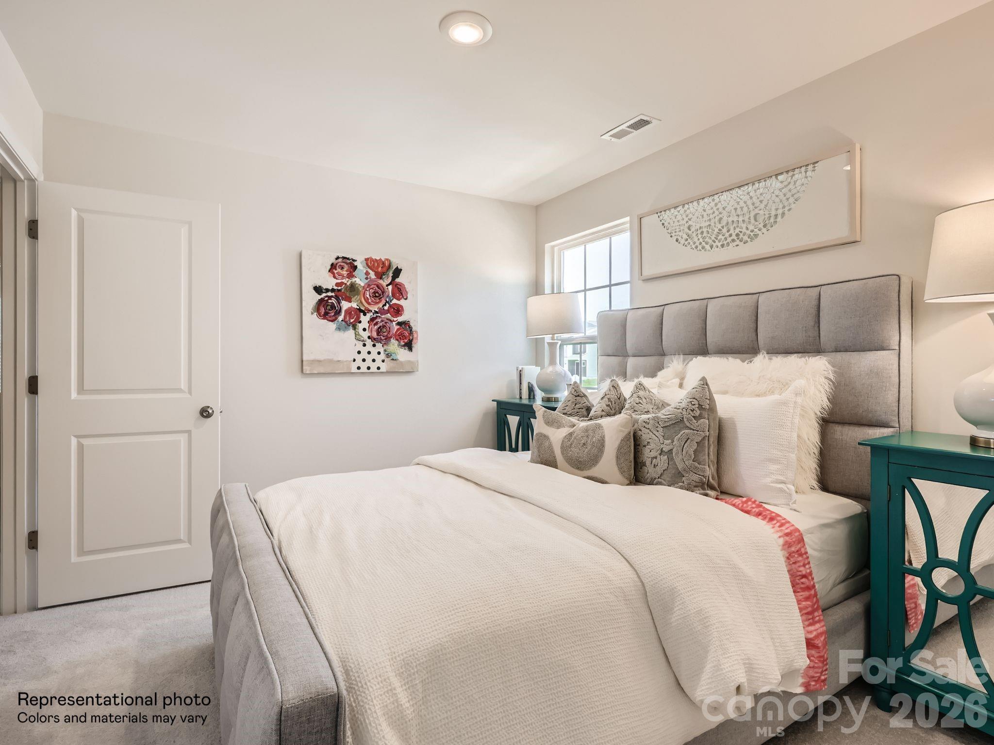 159 Astor Street Troutman, NC 28166 - Photo 21 of 24 a bed room with a bed and a painting