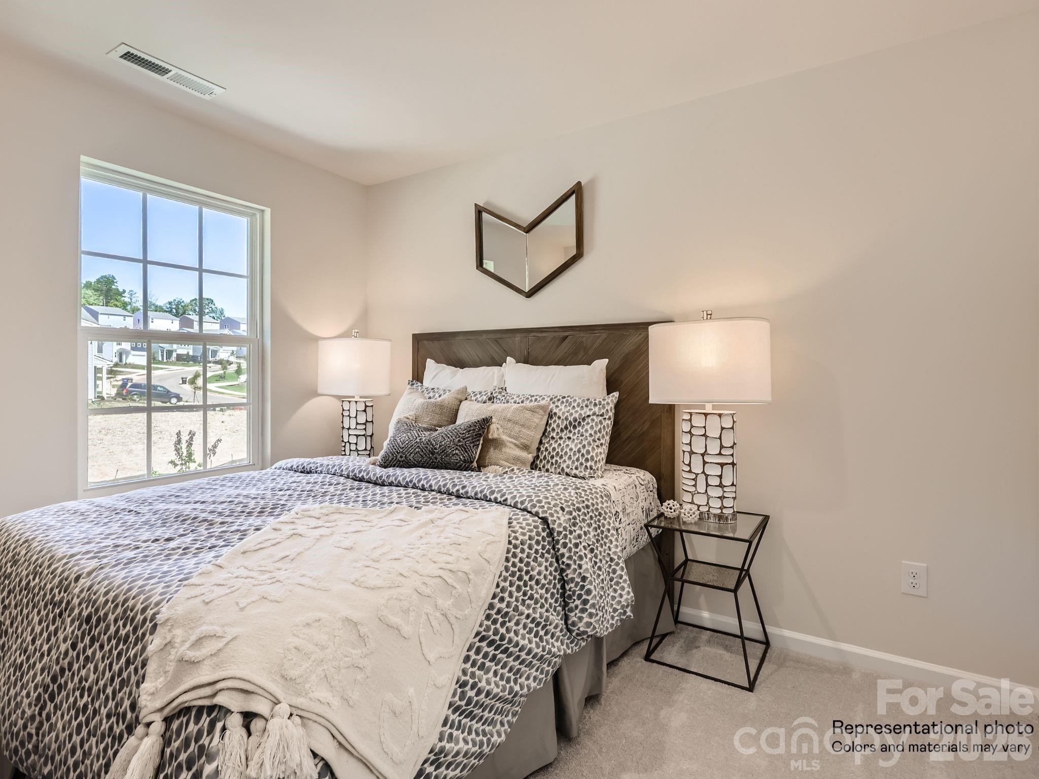 159 Astor Street Troutman, NC 28166 - Photo 23 of 24 a bedroom with a bed and window