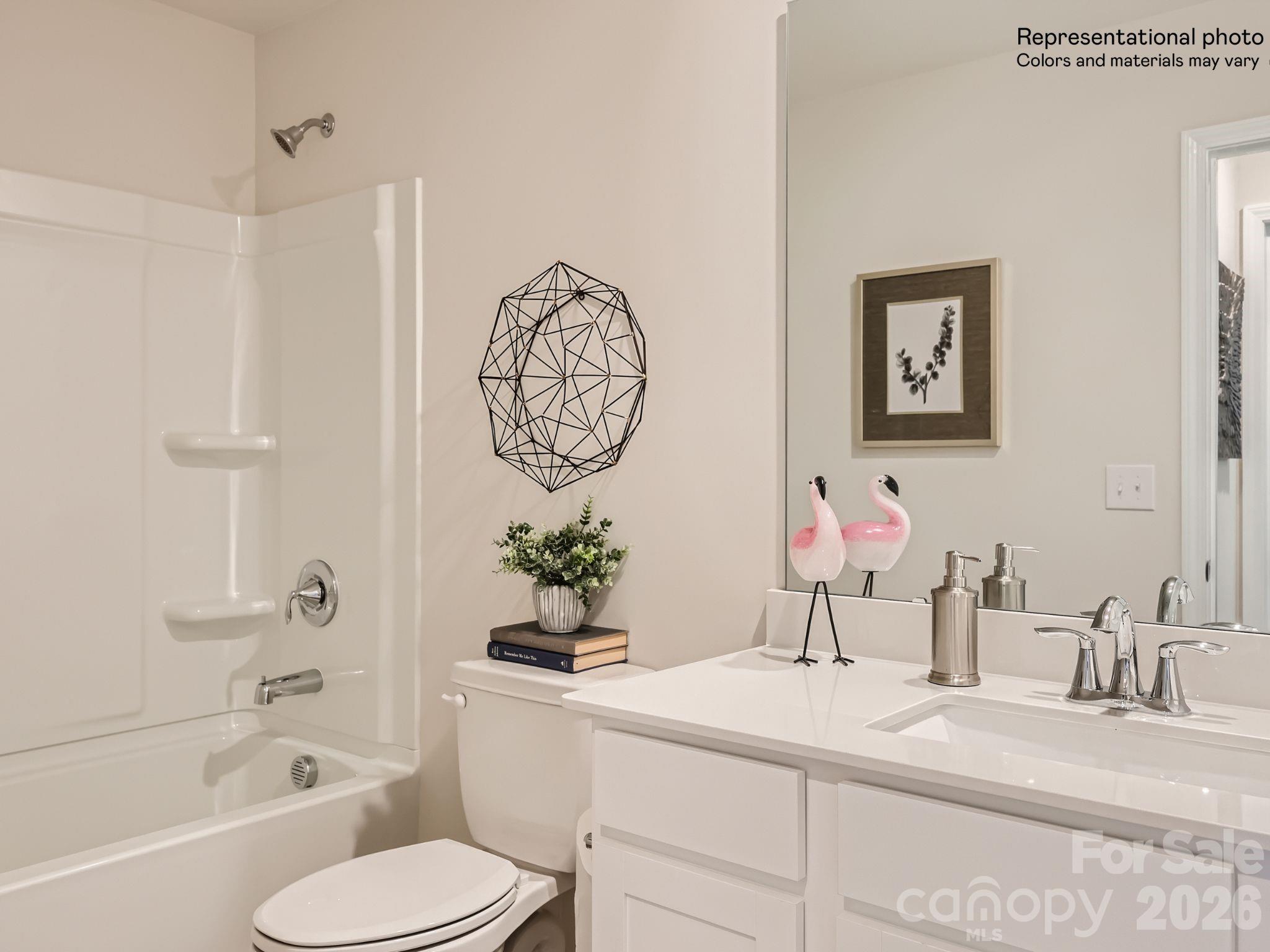 159 Astor Street Troutman, NC 28166 - Photo 24 of 24 a bathroom with a granite countertop sink mirror vanity and toilet