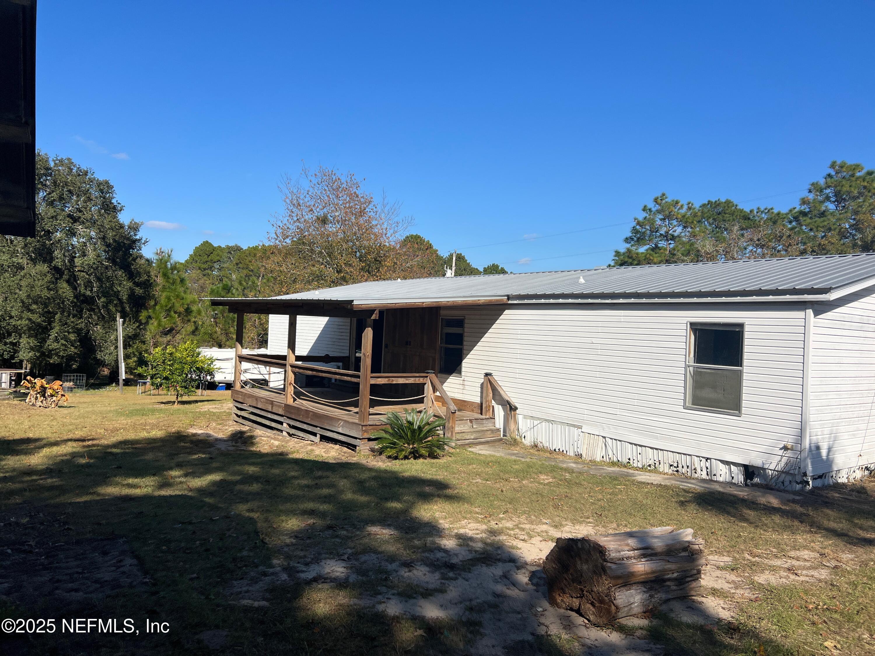323 Incline Road Satsuma, FL 32189 - Photo 3 of 12 a view of a house with a yard