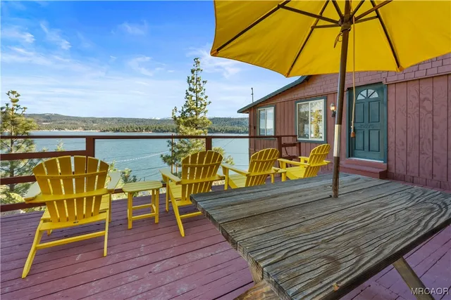 a view of a balcony with chairs and wooden floor
