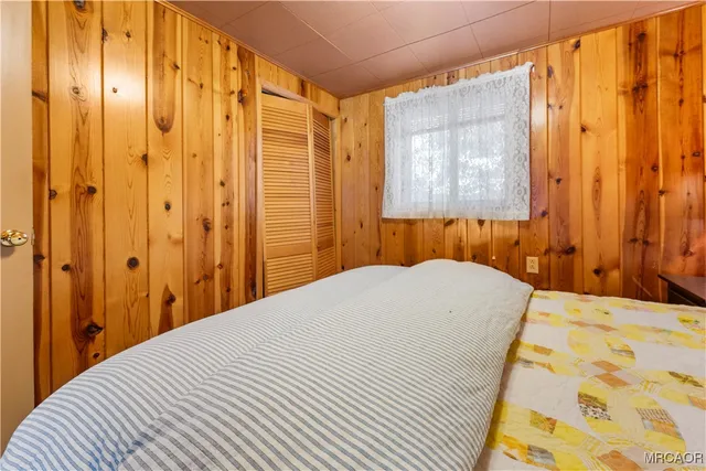 a bedroom with a bed and a mirror