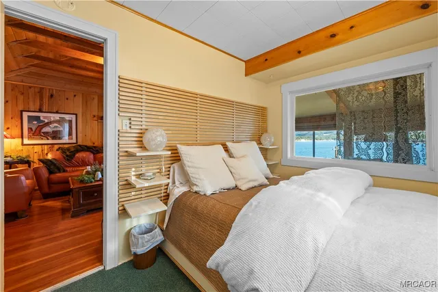 a bed room with a bed and a large window