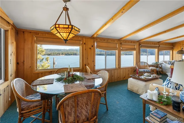 a dining room with furniture a chandelier and wooden floor