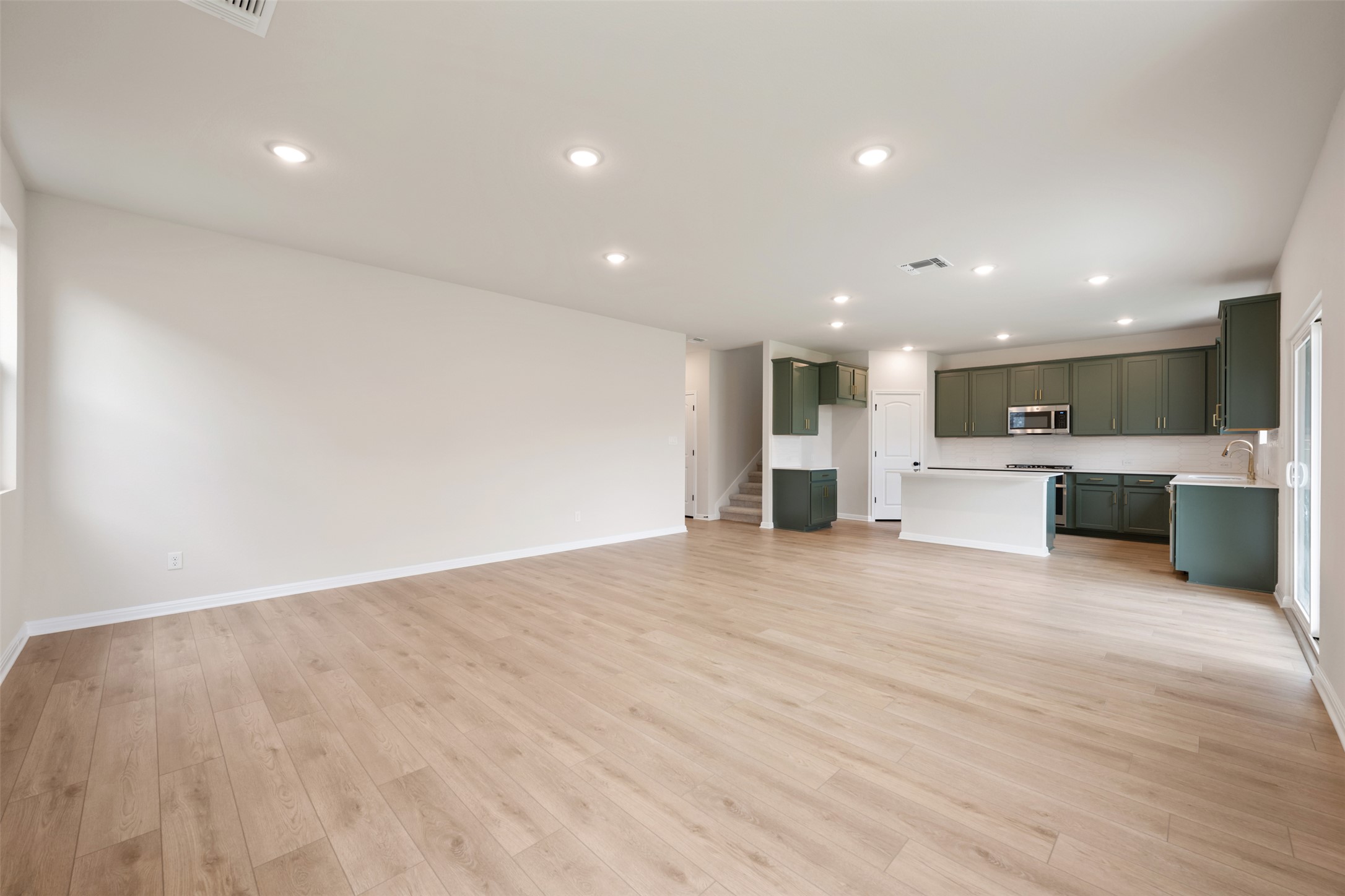 1832 Fannie Road Georgetown, TX 78633 - Photo 12 of 40 a view of kitchen with kitchen island a sink wooden floor and center island
