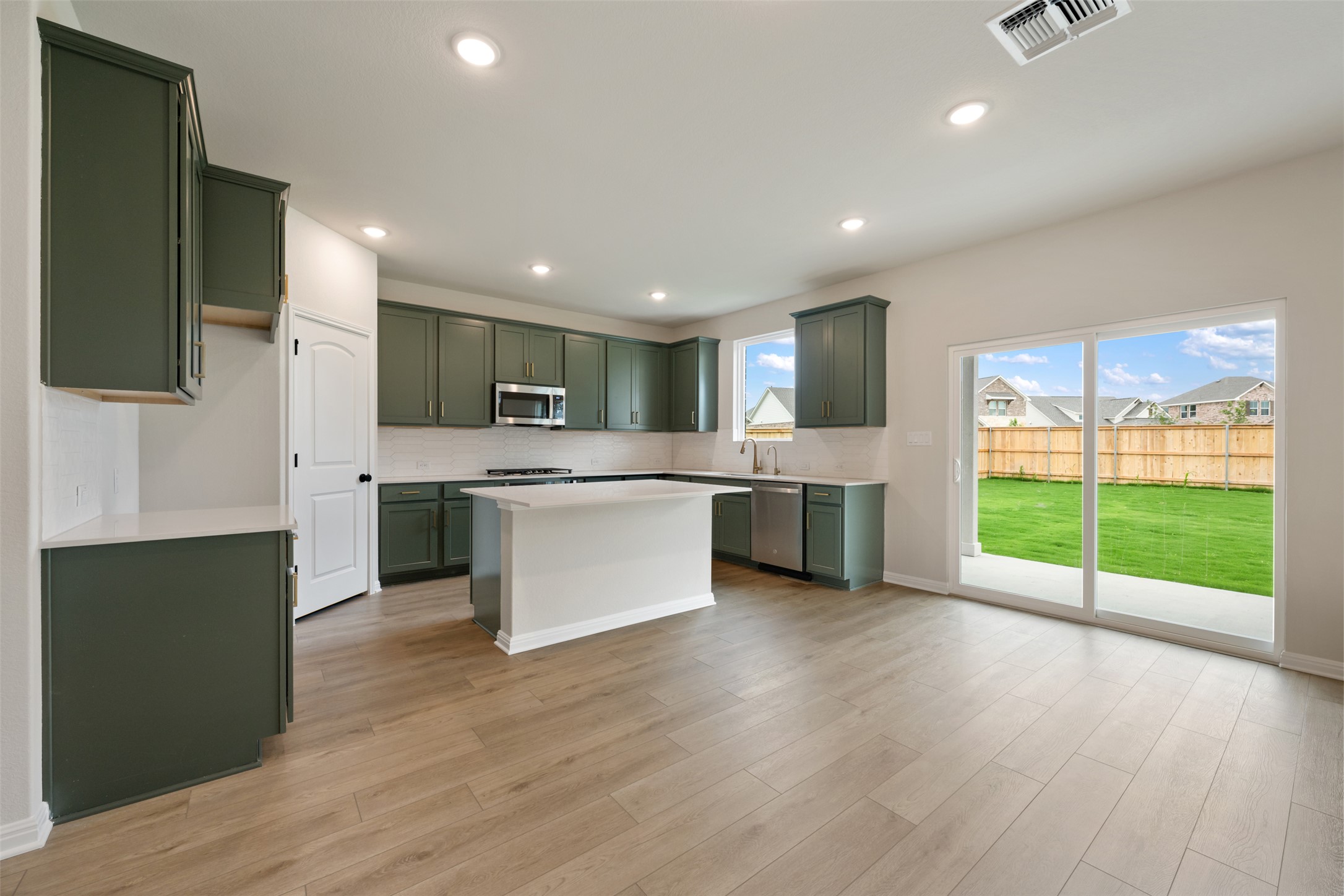 1832 Fannie Road Georgetown, TX 78633 - Photo 16 of 40 a large kitchen with stainless steel appliances granite countertop a stove a sink and a microwave