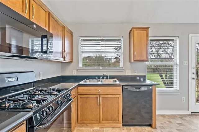 a kitchen with granite countertop a stove and a sink