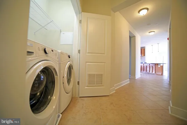 a view of a hallway with washer and dryer