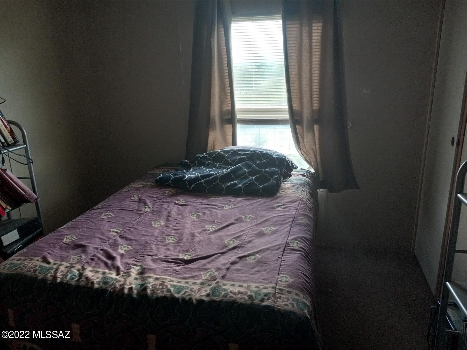 1453 North Taylor Road Willcox, AZ 85643 - Photo 11 of 31 a bedroom with a bed and a window