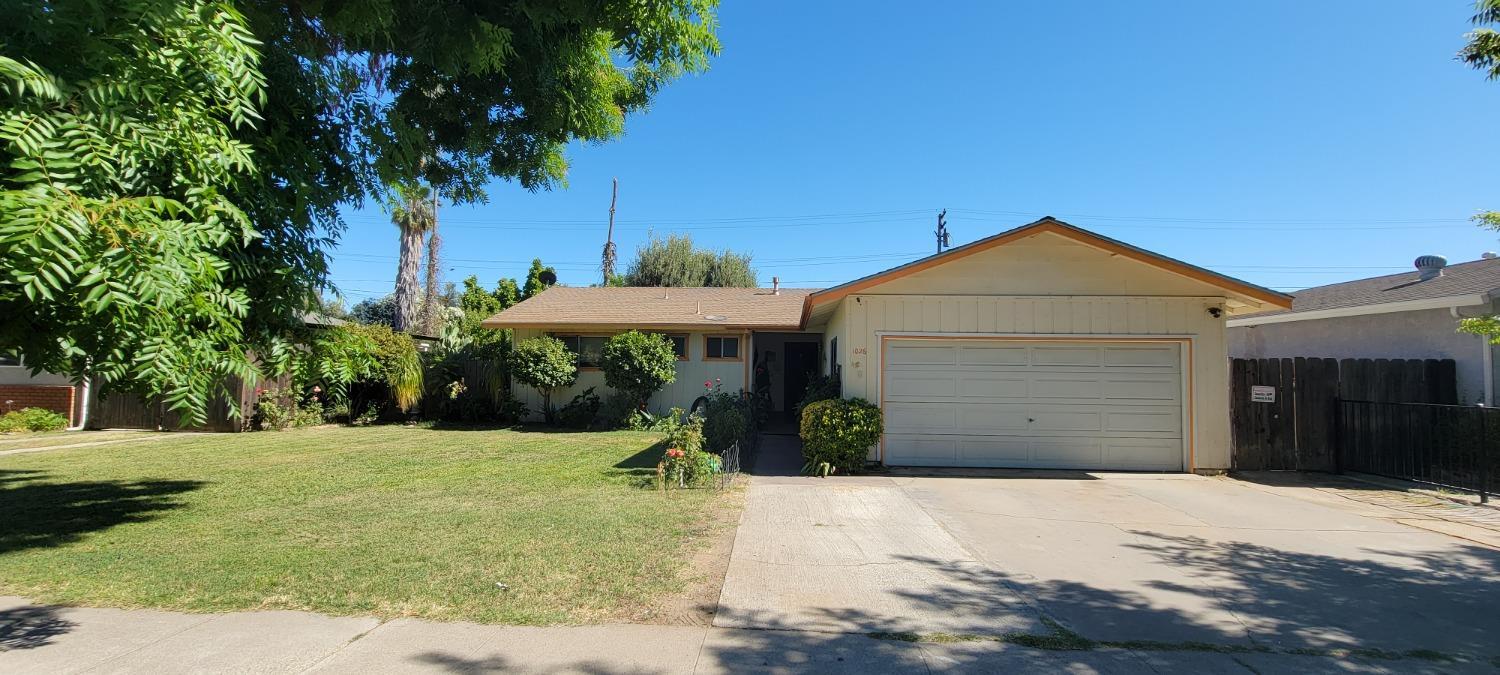 1026 Elm Avenue Modesto, CA 95351 - Photo 1 of 1 a front view of a house with a yard