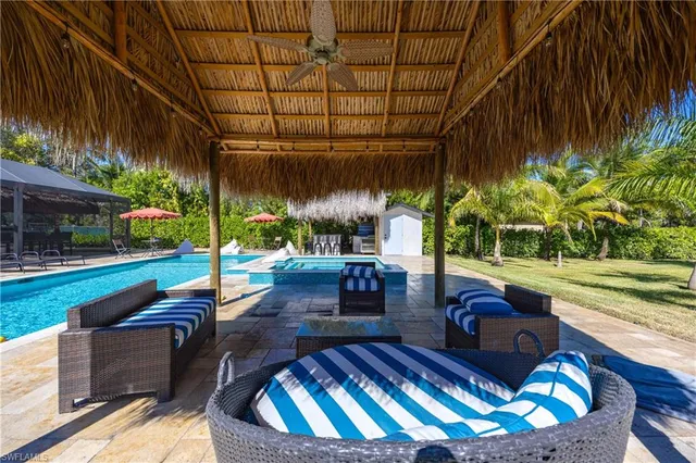 a swimming pool with outdoor seating and yard