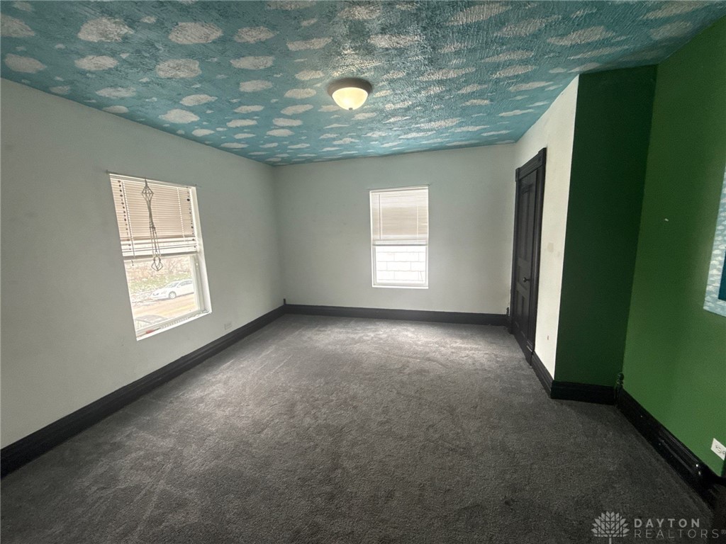 1125 West High Street Springfield, OH 45506 - Photo 24 of 39 An inviting room awaits your personal touch with a distinctive ceiling and ample natural light.