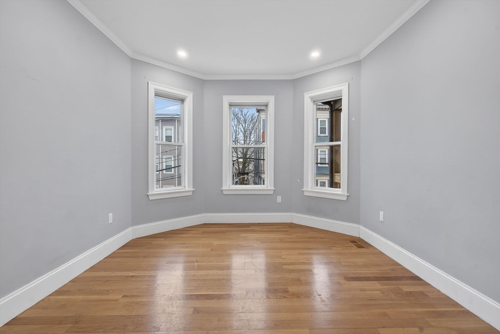 29 East Street, Unit 2 Boston, MA 02122 - Photo 3 of 15 a view of empty room with wooden floor and fan
