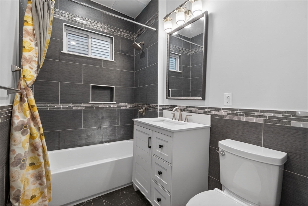 29 East Street, Unit 2 Boston, MA 02122 - Photo 7 of 15 a bathroom with a sink toilet and tub