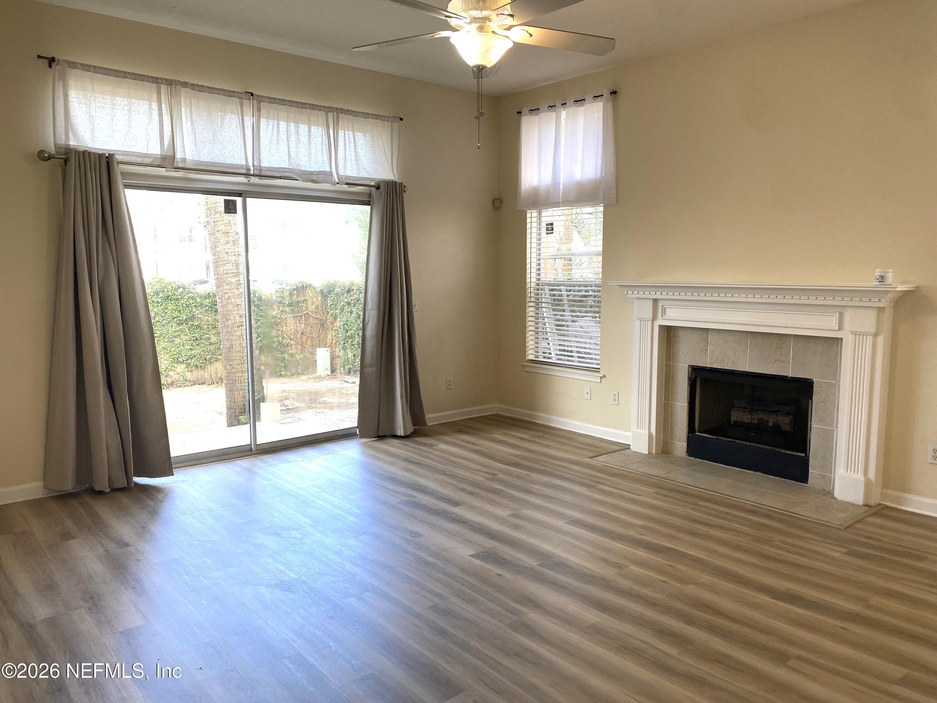 120 Seminole Road Atlantic Beach, FL 32233 - Photo 2 of 21 a view of an empty room with wooden floor and a window