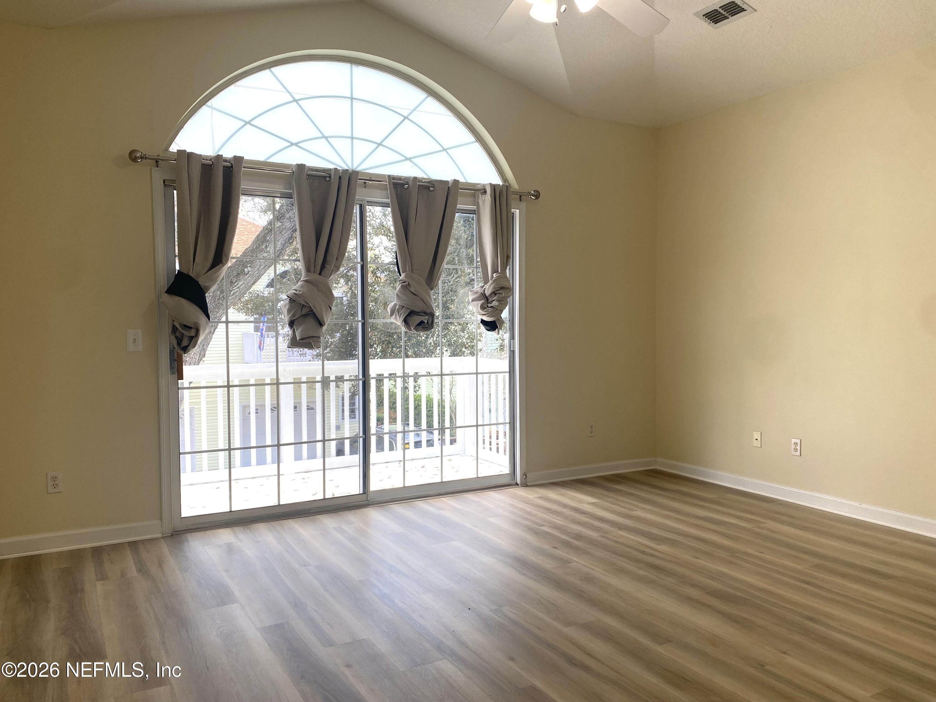 120 Seminole Road Atlantic Beach, FL 32233 - Photo 5 of 21 an empty room with wooden floor fan and windows