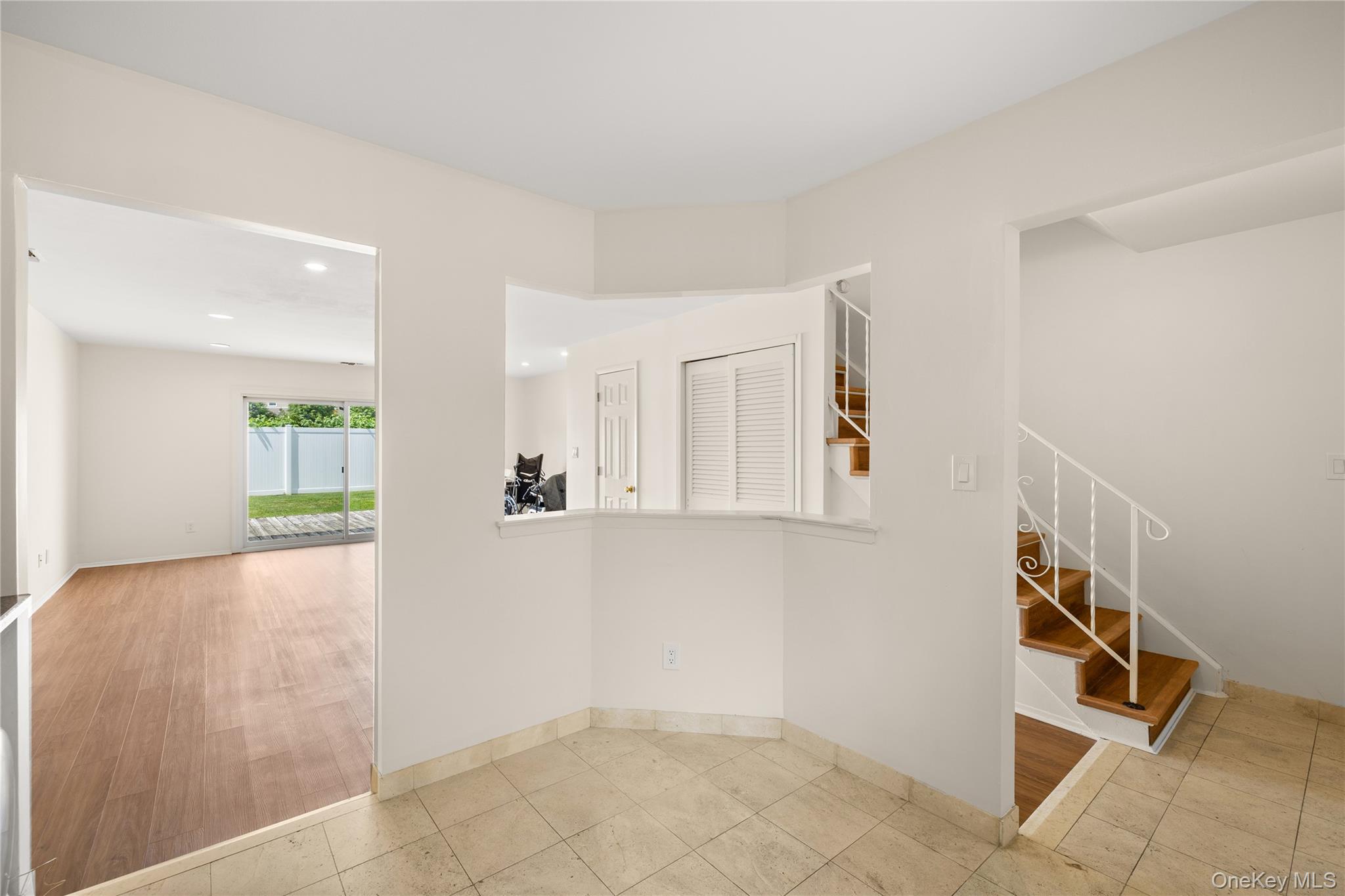 650 Newbridge Road, Unit 15 East Meadow, NY 11554 - Photo 7 of 20 a view of a hallway to rooms and wooden floor