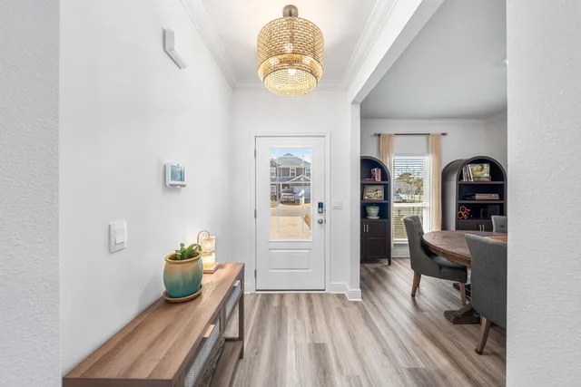 a view of a dining room with a table and chairs