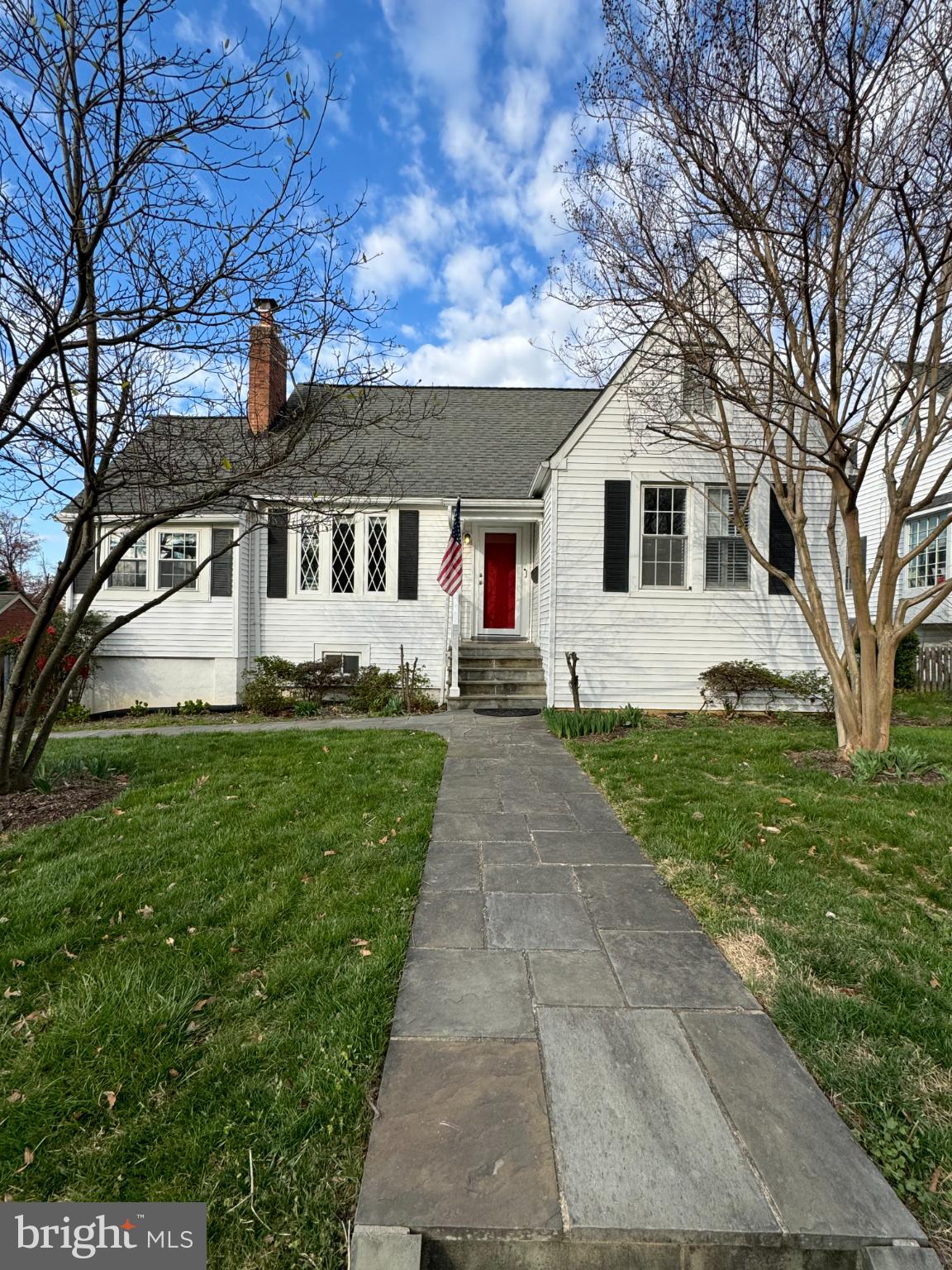 Charming home with inviting entrance and greenery.