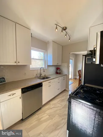 a kitchen with a stove a sink and a refrigerator