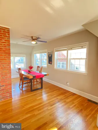 a dining room with furniture and floor to ceiling windows