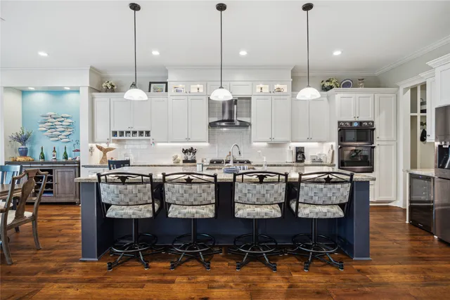 a large kitchen with lots of counter space furniture and appliances