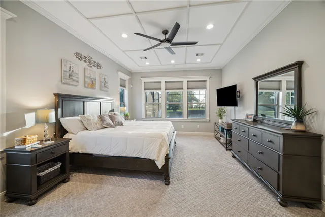 a spacious bedroom with a bed and a chandelier