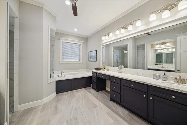 a spacious bathroom with a large tub sink and mirror