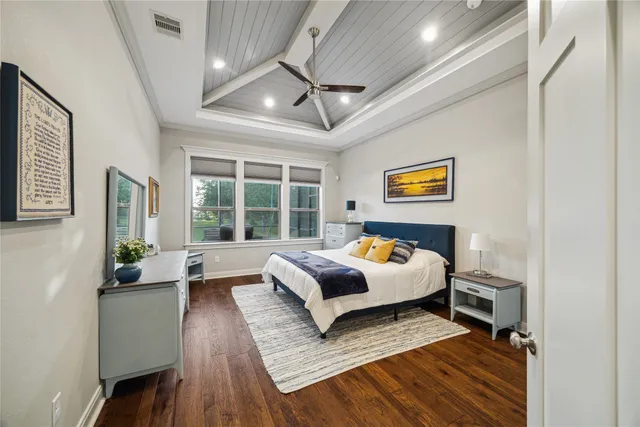 a bedroom with furniture and a large window