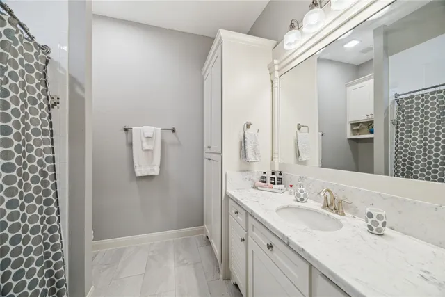 a bathroom with a double vanity sink and mirror