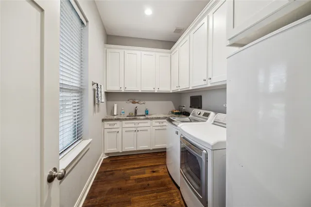 a kitchen with a sink a stove and cabinets