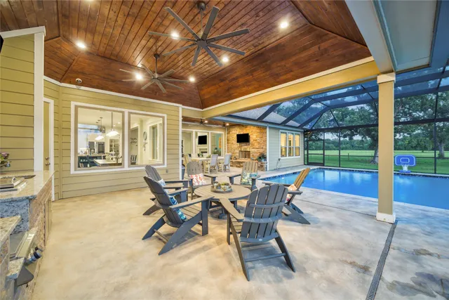 a view of a patio with table and chairs and potted plants