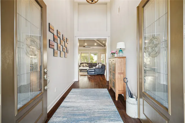 a view of a hallway with wooden floor windows and livingroom
